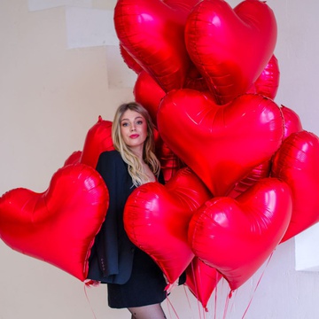 An armful of red heart balloons L