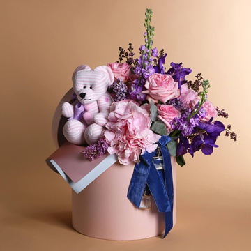 Floral composition with a striped bear