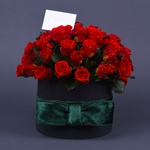 Composition of red roses in hatbox
