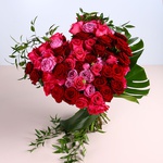 Bouquet of bright roses in the shape of a heart