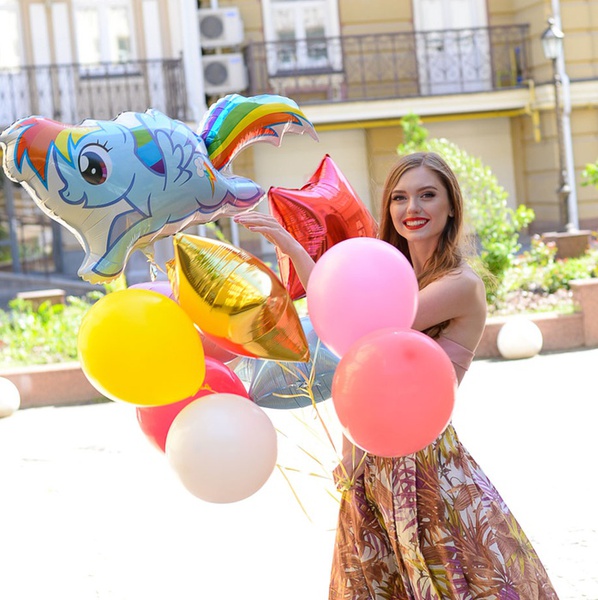 An armful of balloons with ponies