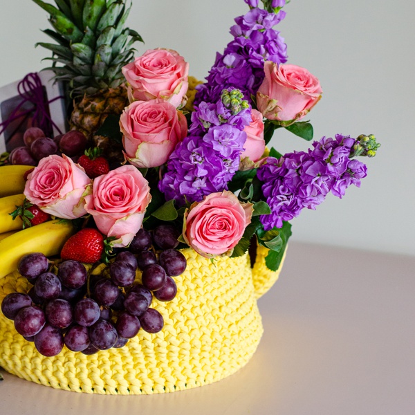 Wicker box with fruits and flowers