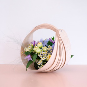 Flower composition in a basket with a lemon rose