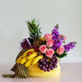 Wicker box with fruits and flowers