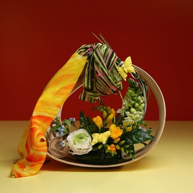 Composition in a basket with a yellow scarf