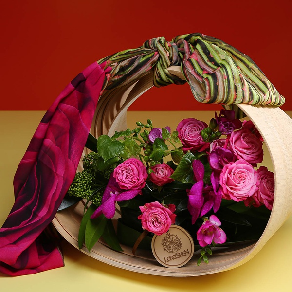 Composition in a basket with a raspberry scarf