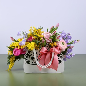 Floral composition in a purse pink-lilac