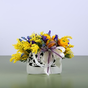 Floral composition in a hand bag yellow-violet
