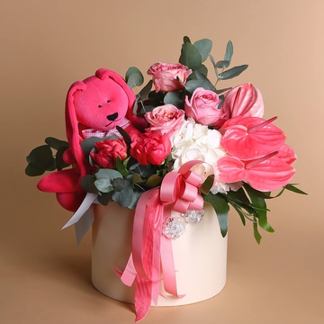Flowers in a hatbox with soft toy pink bunny