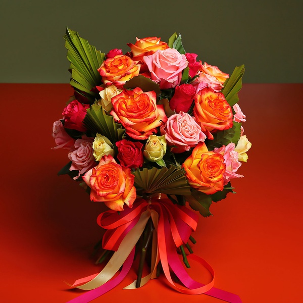 Bouquet of mix roses and palm leaves