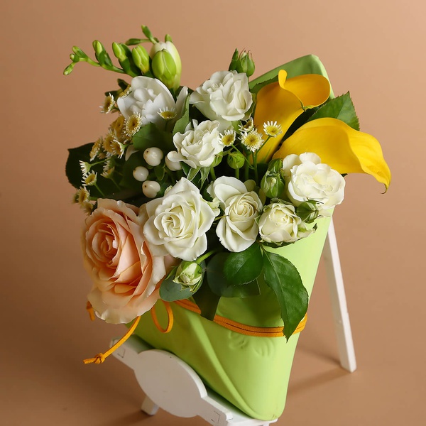Floral composition with yellow accents in an envelope