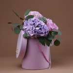 Peonies and hydrangea in a hatbox