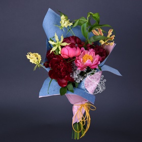 Bouquet with peonies in denim packaging