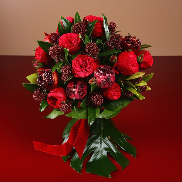 Bouquet of bordeaux roses and pomegranate