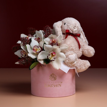 Flowers in a box with a soft toy