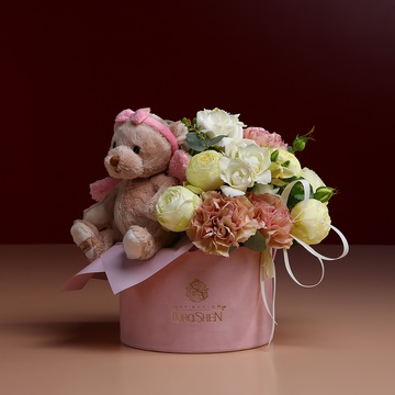 Flowers in a hatbox with teddy bear