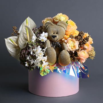 Floral composition with a golden bear