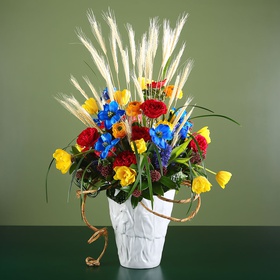 Ethno composition in a vase with leaves