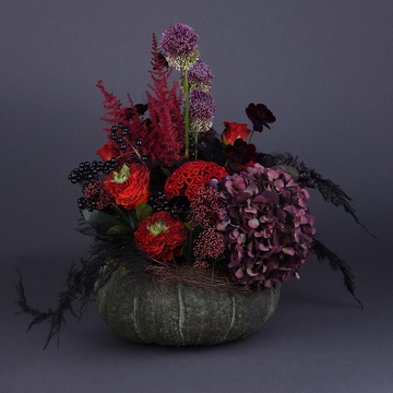 Floral composition in burgundy pumpkin with black