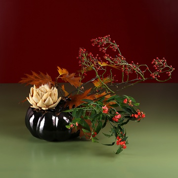 Minimalist composition in a pumpkin vase